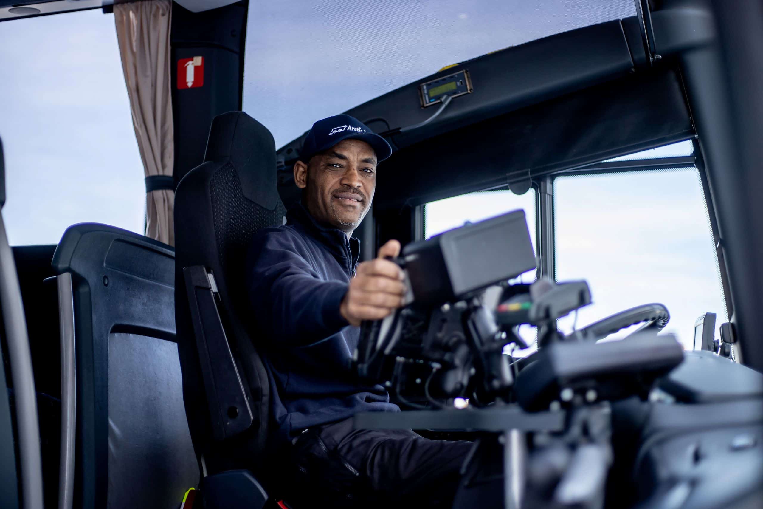 Busschaufför på sin arbetsplats. Glad man.